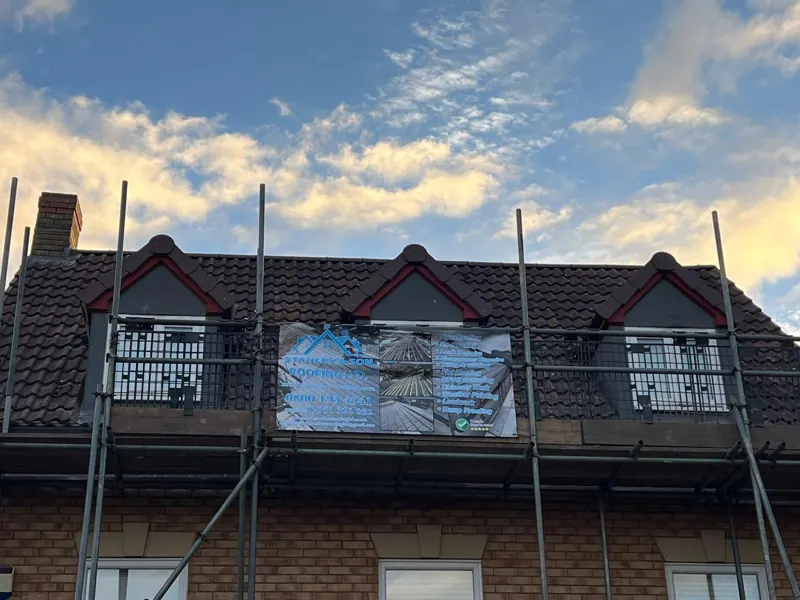 Stanley & Son Roofing banner on the scaffold across the three front dormers of the Milton Keynes house