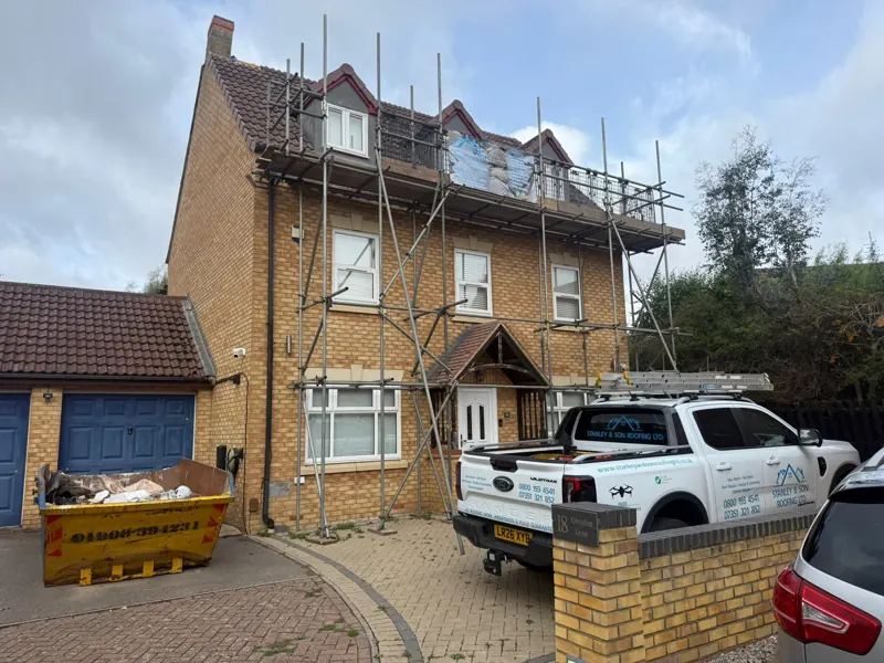Front of the three-storey detached house in Milton Keynes with full scaffold, skip and branded pick-up