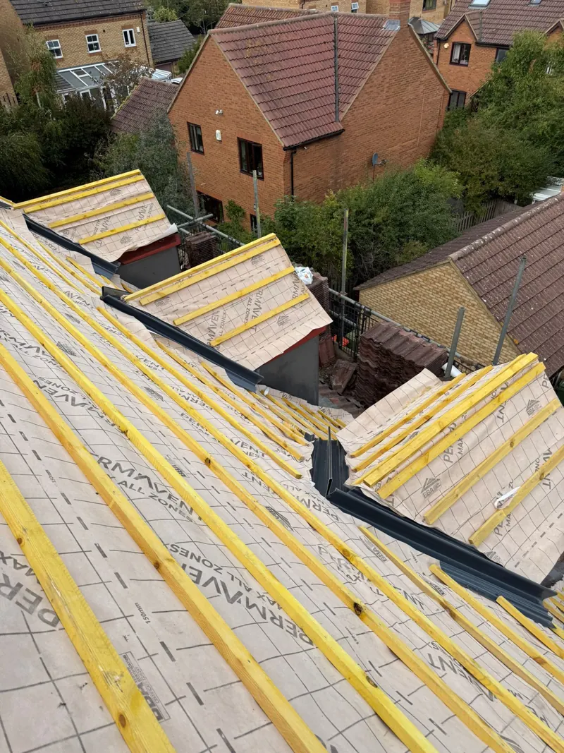Permavent breathable membrane laid across the slopes with new treated battens fixed to gauge, dormer valleys flashed