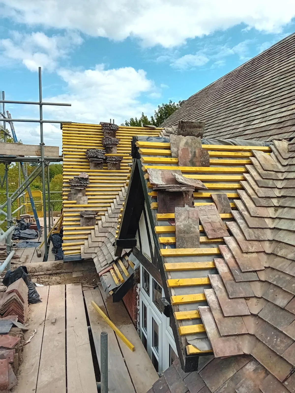 Roof stripped to battens and felt showing the timber condition underneath